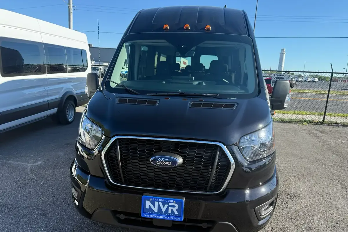 Black high-roof 12 or 15 passenger van, front view