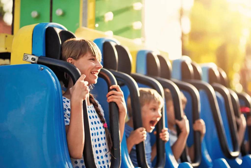 Children enjoy a thrilling amusement park ride.