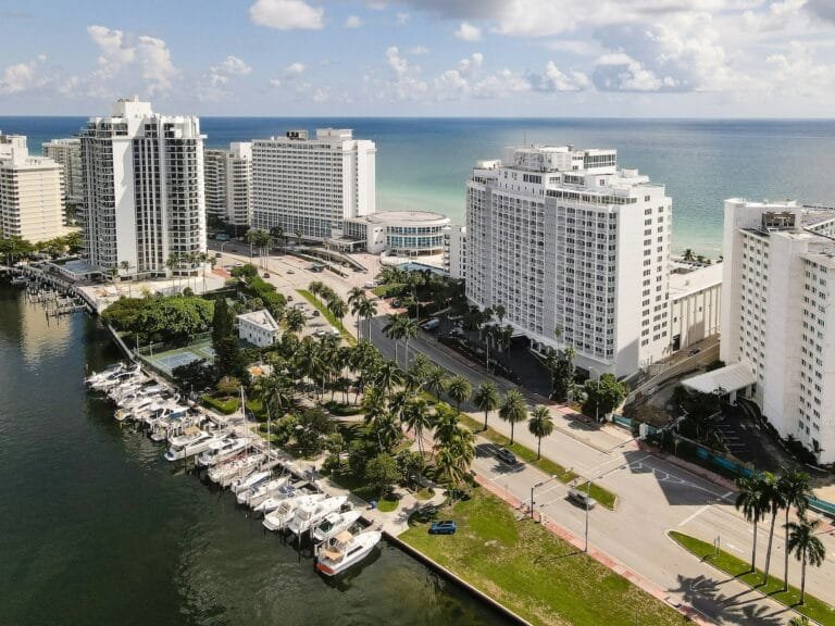 Aerial view of Miami beachfront hotels and marina.
