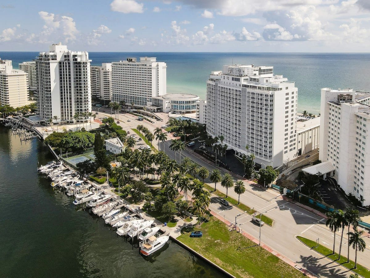 Aerial view of Miami beachfront hotels and marina.